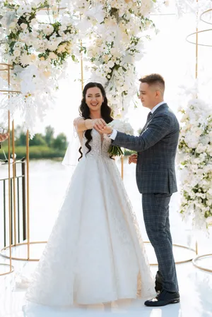 Happy groom and bride celebrate love outdoors with flowers