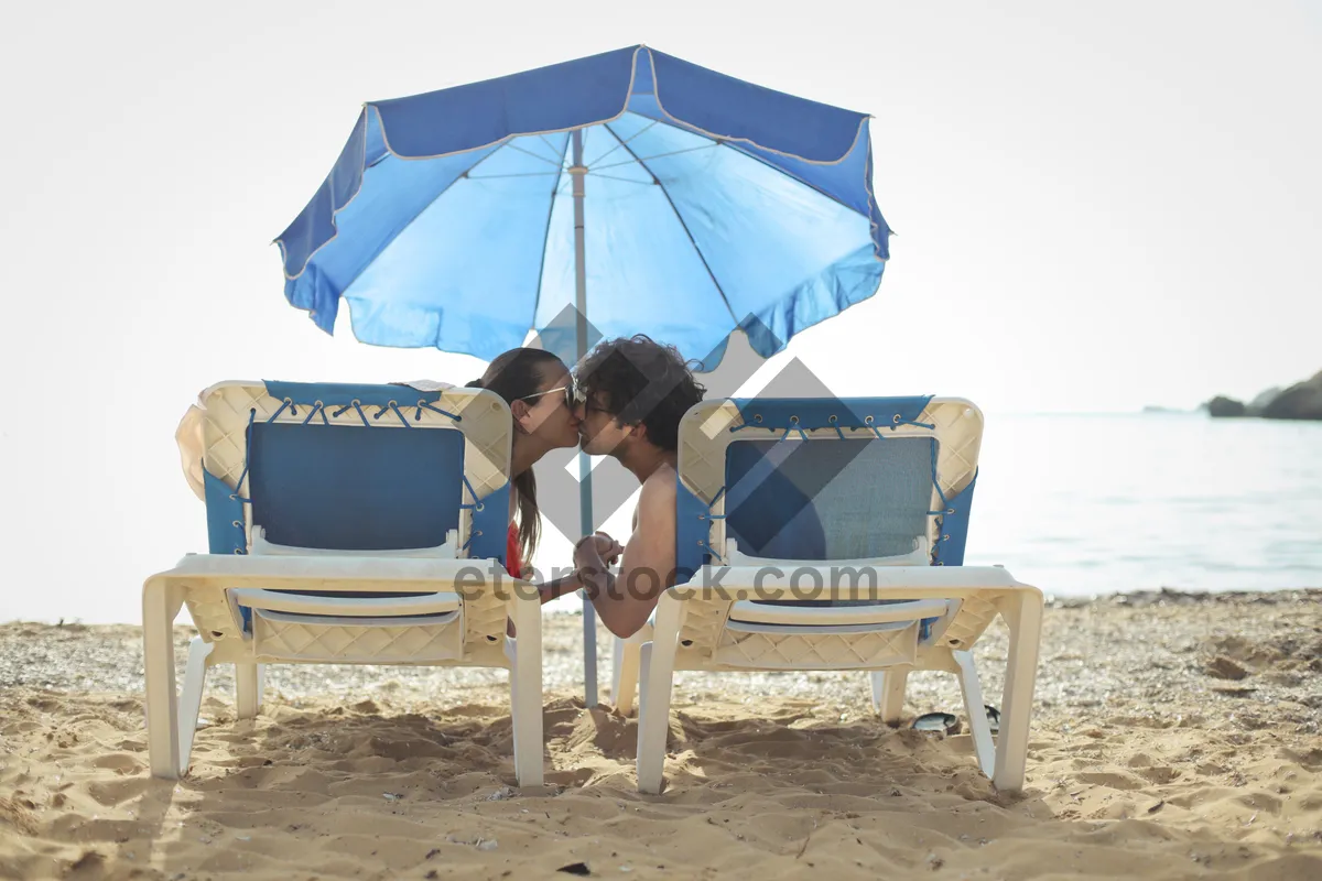 Picture of Beach umbrella provides shelter from summer rain.