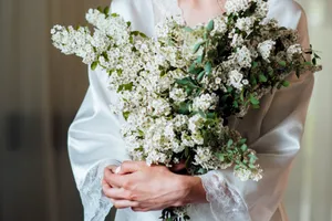 Happy couple at wedding with rose bouquet