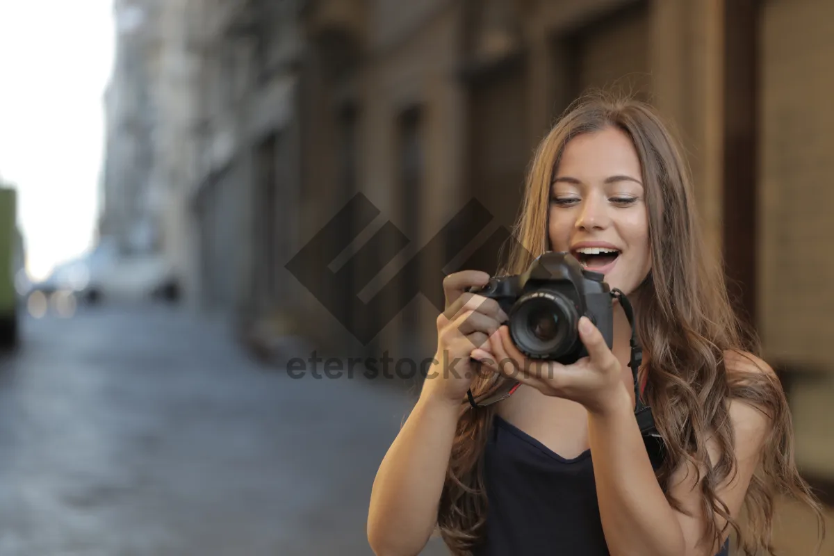 Picture of Portrait of young brunette woman smiling in studio.