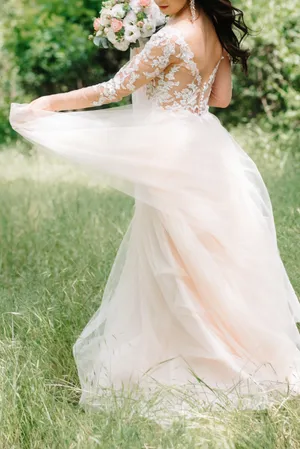 Outdoor wedding photo of smiling blonde bride and groom.