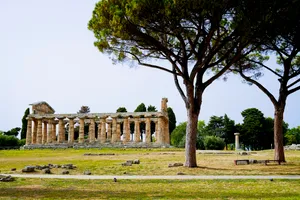 Ancient cemetery temple and stone monument in park.