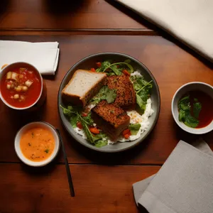 Delicious vegetable salad with grilled fish and fresh sauce.