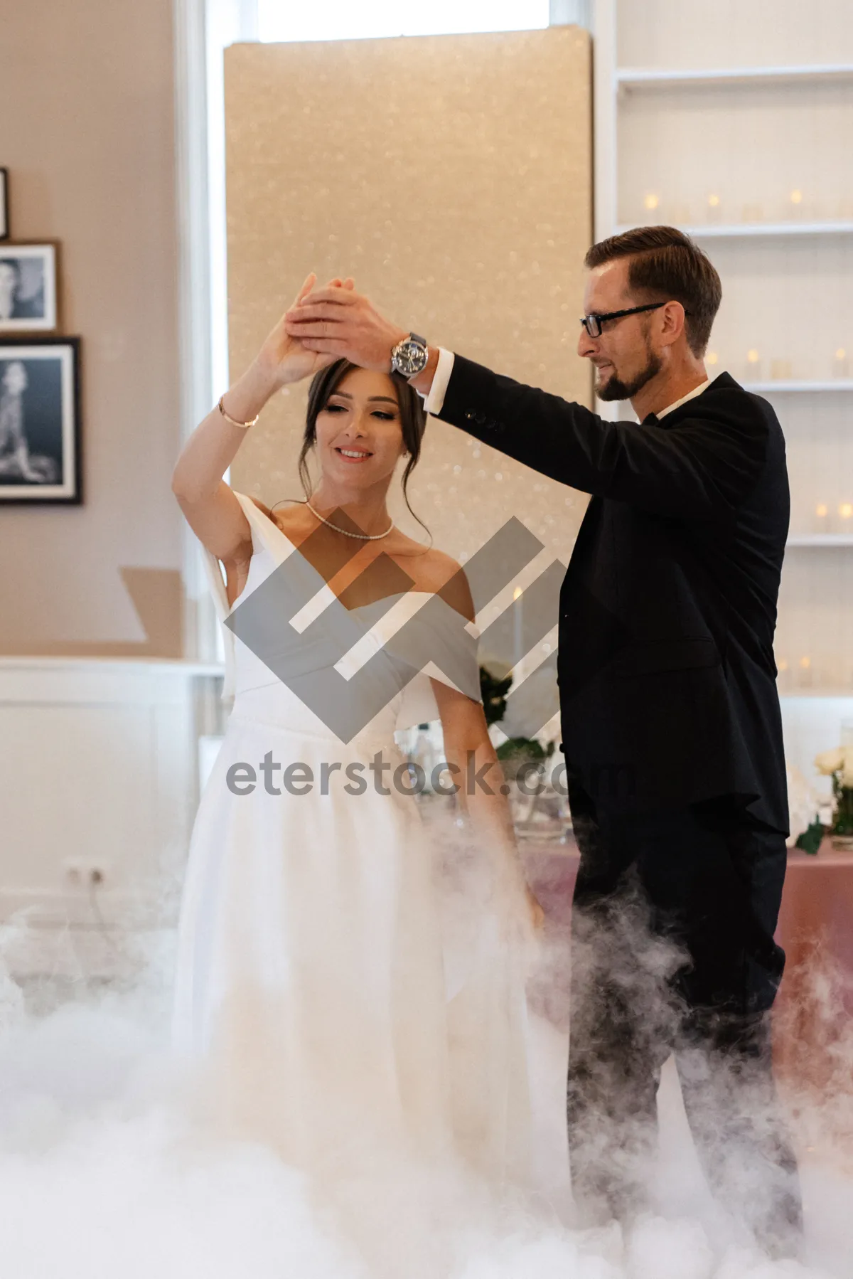 Picture of Happy couple celebrating wedding with flowers and smile