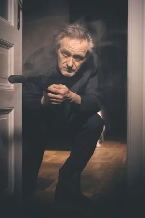 Elderly man portrait in black clothing at elevator