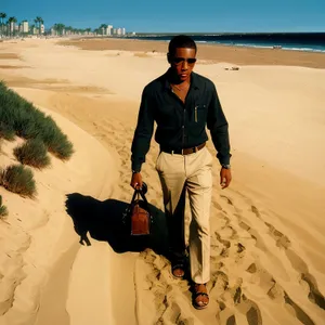 Man relaxing on sunny beach by the ocean