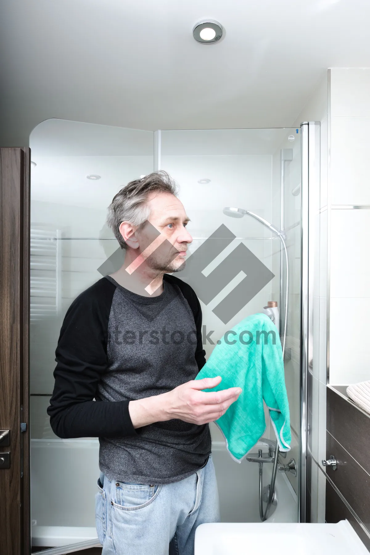 Picture of Happy man smiling with hand blower at home