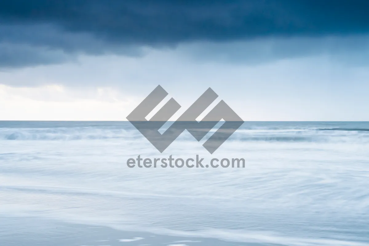 Picture of Tropical sunset over tranquil ocean shore.