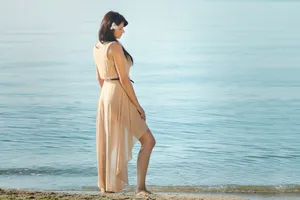 Happy person enjoying beach vacation in stylish clothing