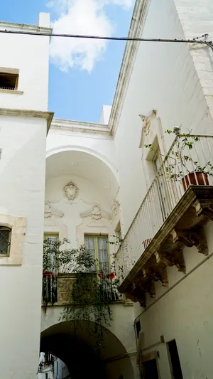 Historic cathedral in old city with balcony and tower.