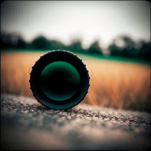 Hand holding magnifying glass with lens cap