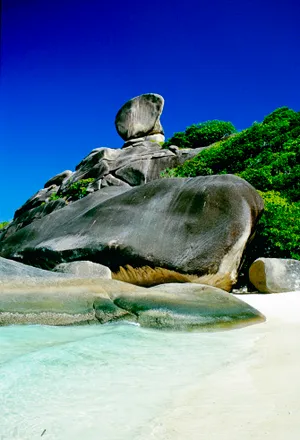 Rocky landscape with turtle statue by the water. The colors and crystal clear water of the archipelago of the Similan Islands National Park, Thailand, Asia