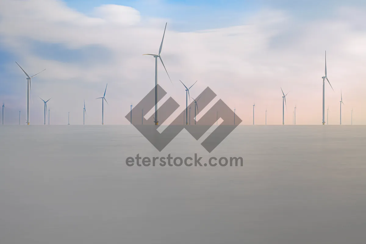 Picture of Renewable energy wind turbines against a cloudy sky landscape