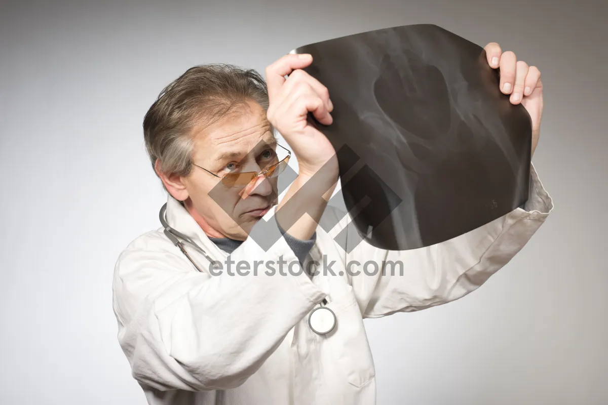 Picture of Happy professional male doctor smiling in lab coat.