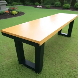 Wooden Pool Table with Chairs on Grass