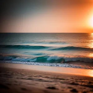 Idyllic Beachscape: Tranquil Waves Kiss Sandy Shoreline at Sunset
