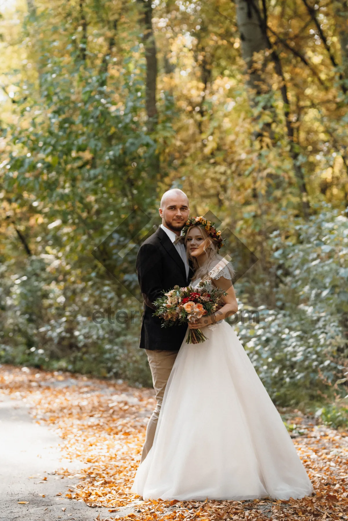 Picture of Happy married couple outdoors in wedding attire