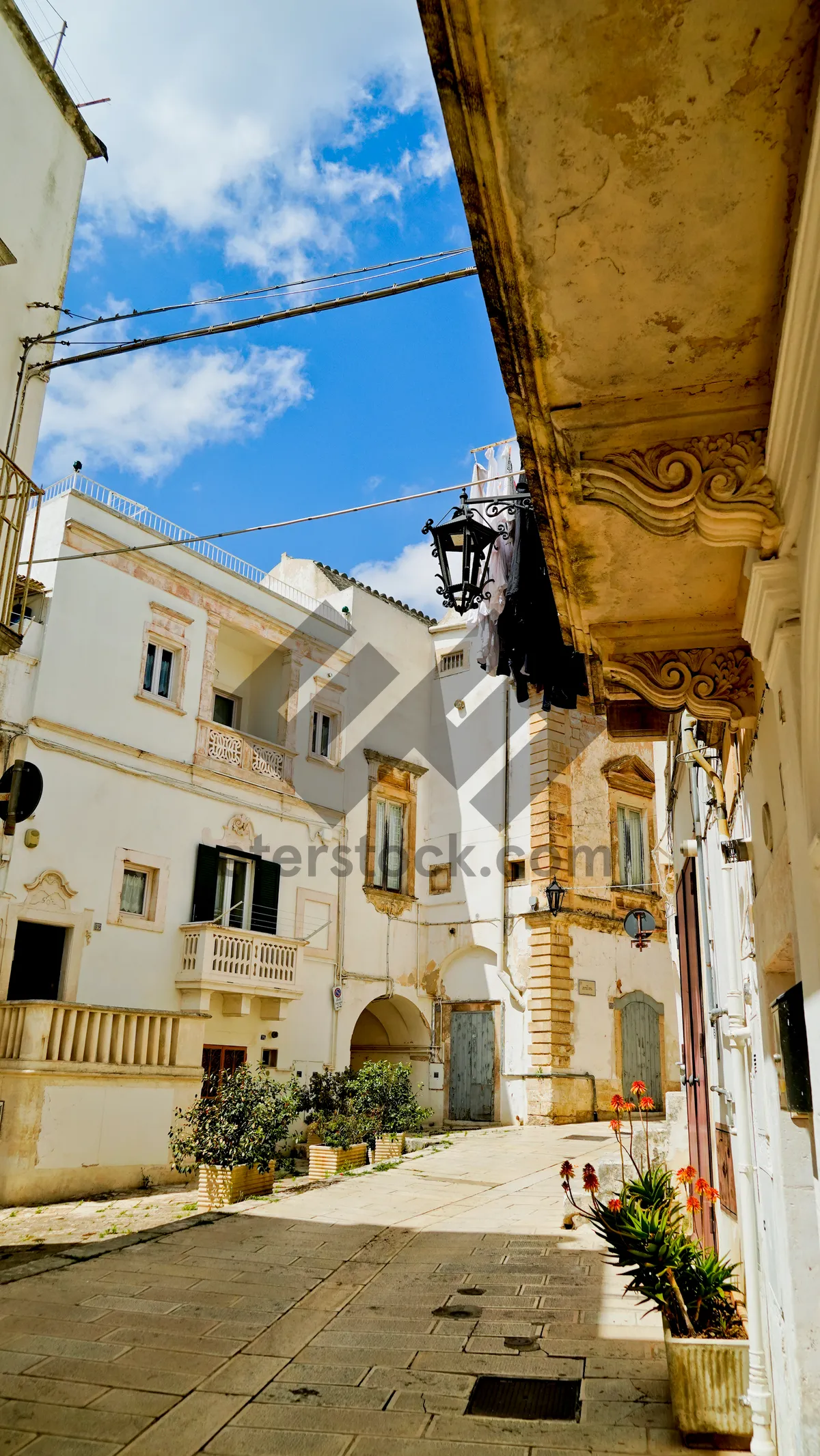 Picture of Historic stone monastery with balcony overlooking ancient cityscape.