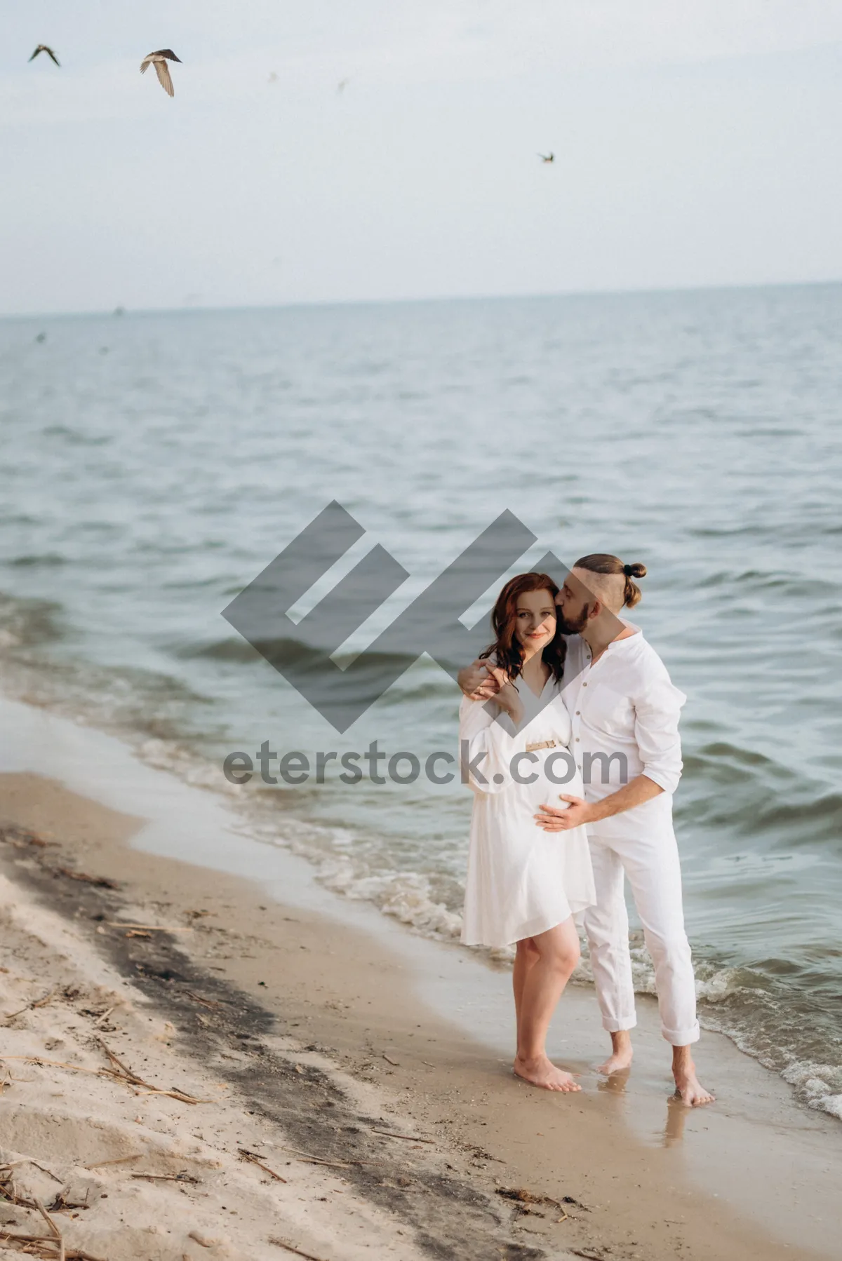 Picture of Happy couple enjoying beach vacation under blue sky