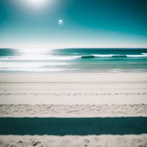 Serene Beachscape: Sun-kissed sands meet turquoise waves.