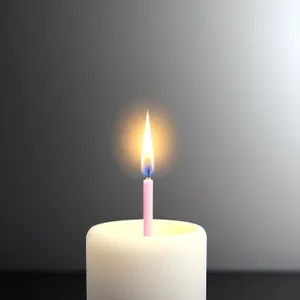 Candlelight illuminating birthday celebration with flaring flame