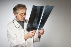 Professional male doctor in white coat with stethoscope