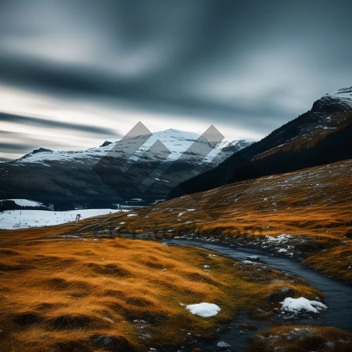 Picture of Glistening snow-covered mountain peaks under cloudy sky