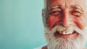 Happy senior man with gray mustache smiling portrait.