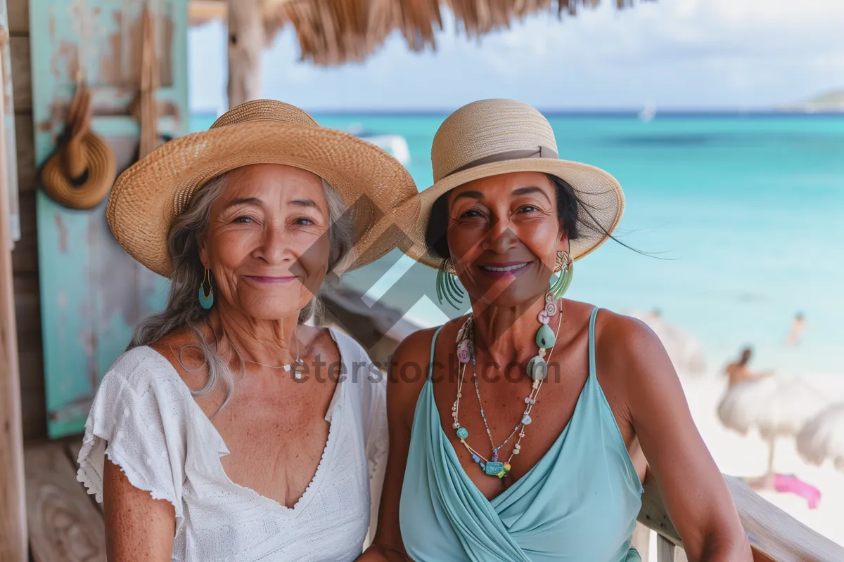 Picture of Happy couple on tropical beach wearing cowboy hat in summer.