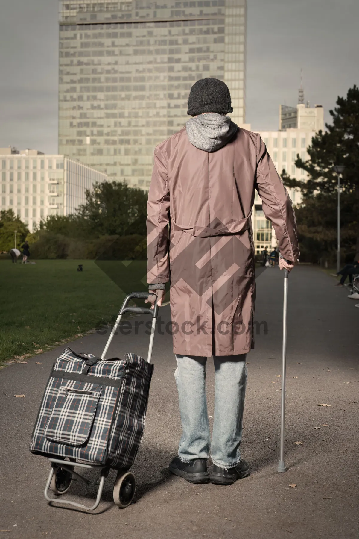 Picture of Man in trench coat walking outdoors in rain