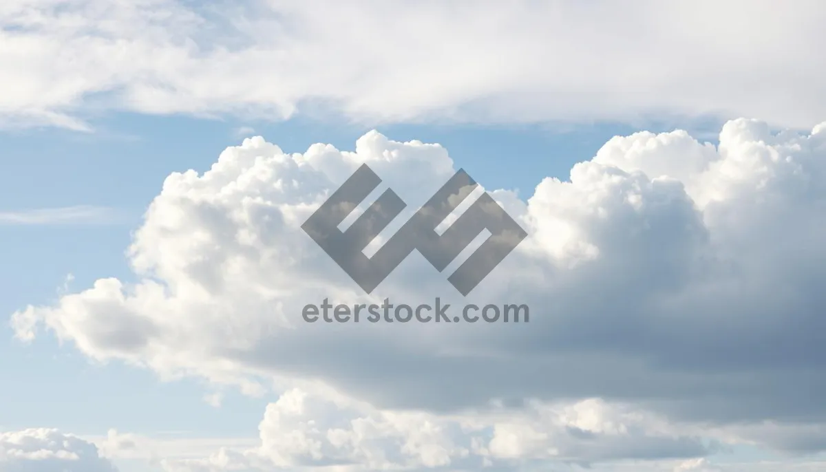 Picture of Bright Sunny Sky with Fluffy Clouds.