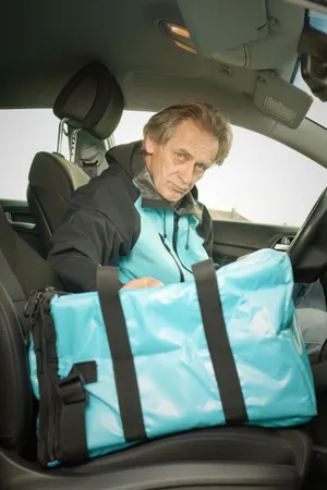 Happy man driving car with seat belt on.