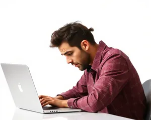 Happy professional man working on laptop in office