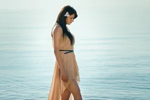 Happy brunette wearing sarong on tropical beach