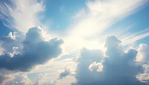 Summer sky with fluffy clouds and bright sun.