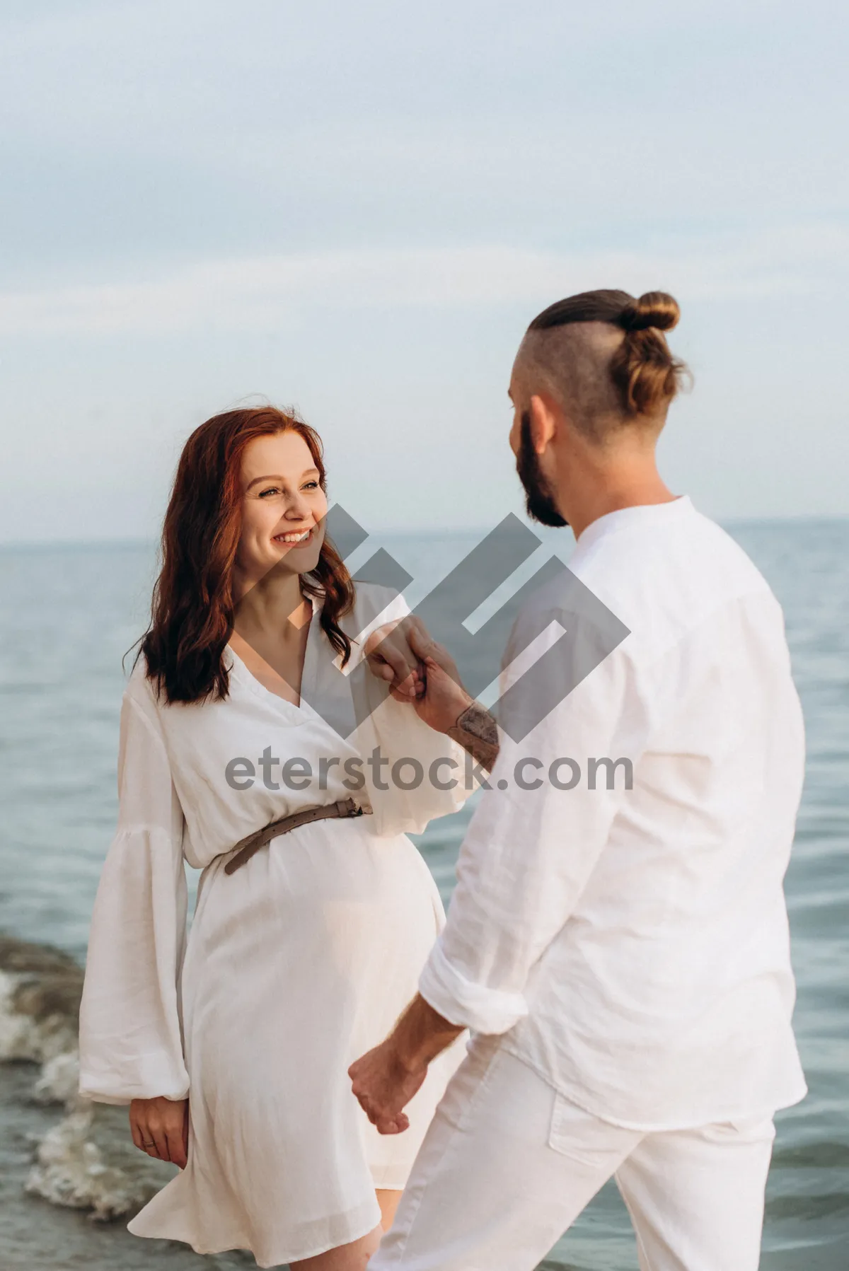 Picture of Happy Couple Enjoying Beach Vacation in Summer Sunshine