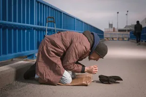 Person sleeping in a sleeping bag under the stars