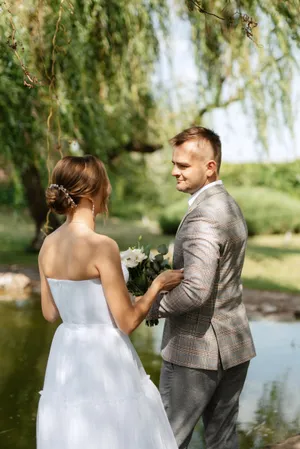 Happy couple in the park on their wedding day.