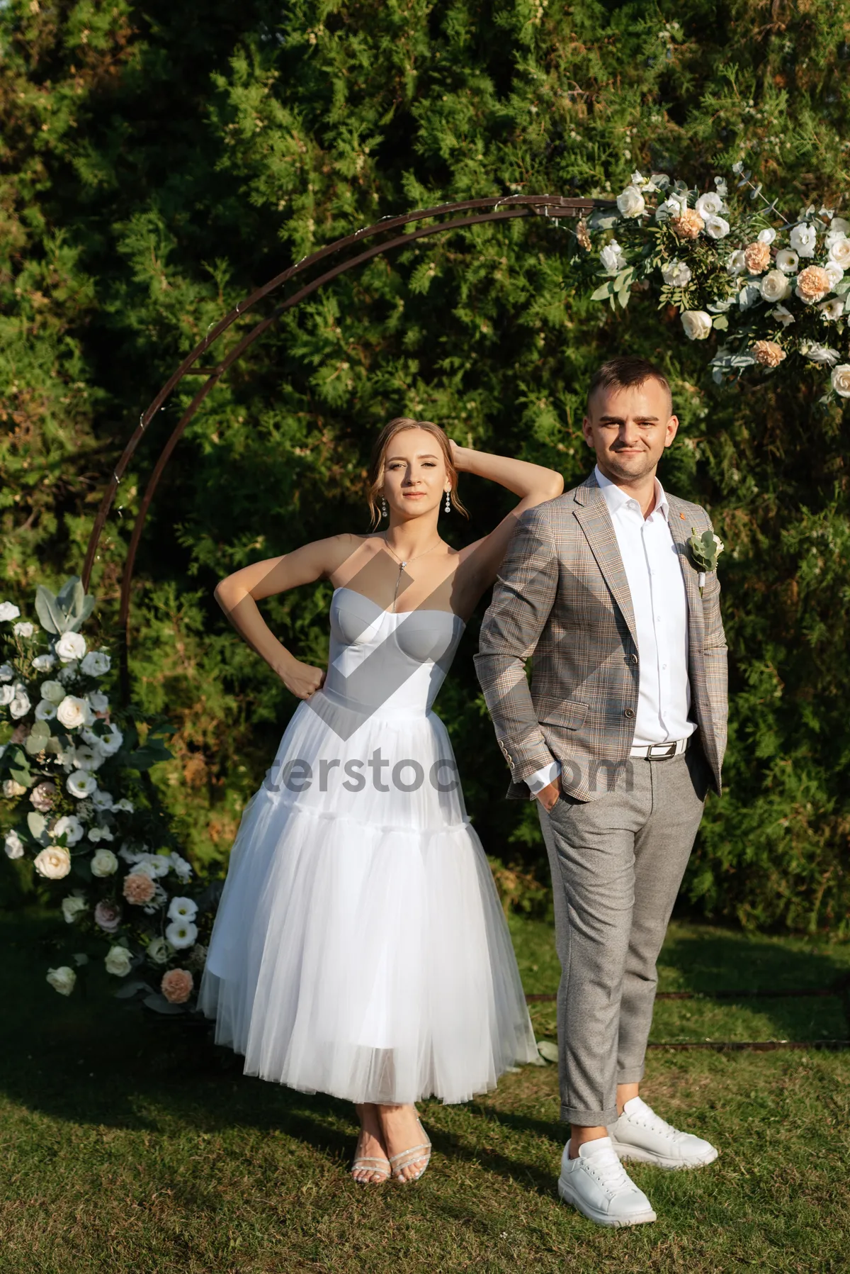 Picture of Happy Wedding Couple Outdoors with Bouquet of Flowers