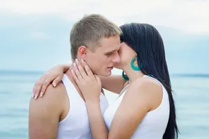 Happy couple enjoying summer vacation together with sunscreen protection