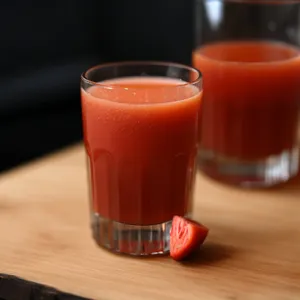 Fresh fruit breakfast drink with ice and lemon