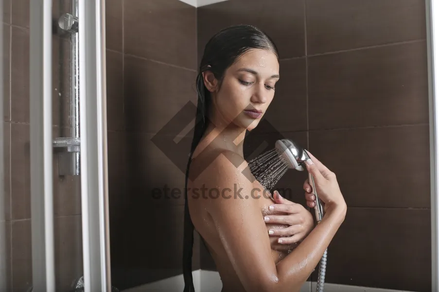 Picture of Attractive brunette model using hand blower appliance.