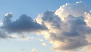 Summer Sky with Fluffy Clouds and Bright Sun