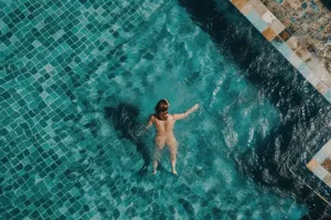 Boy swimming in tropical ocean on summer vacation