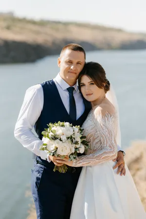 Happy newlywed couple celebrating love with flowers outdoors