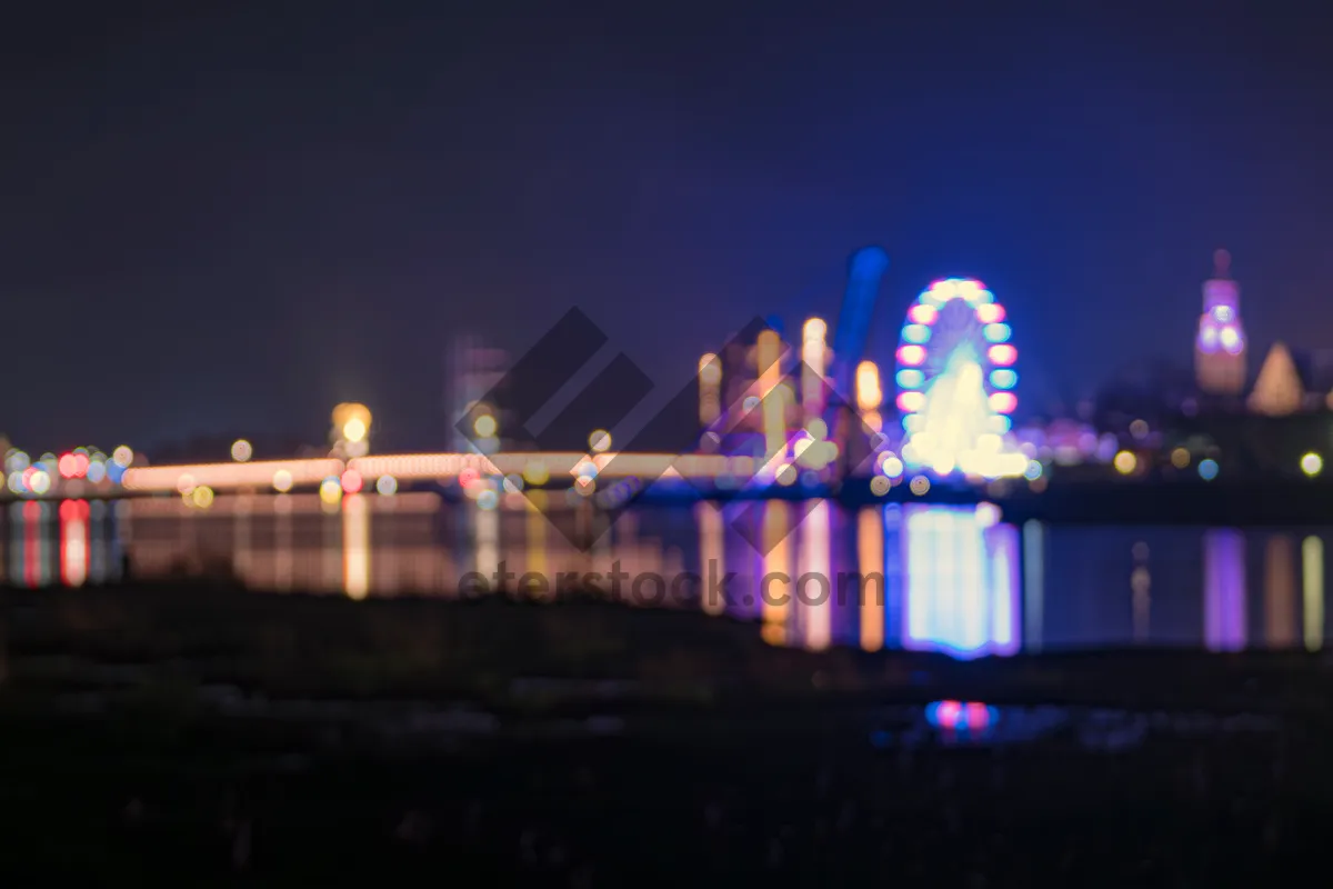 Picture of Urban skyline illuminated at night reflecting on water fountain