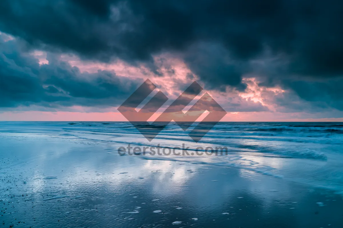 Picture of Tropical Sunset Reflection on Tranquil Ocean Coast.