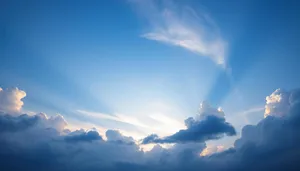 Sunny sky with fluffy clouds in summer landscape.