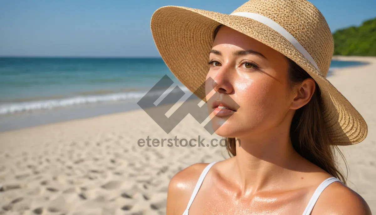 Picture of Smiling model in cowboy hat on beach