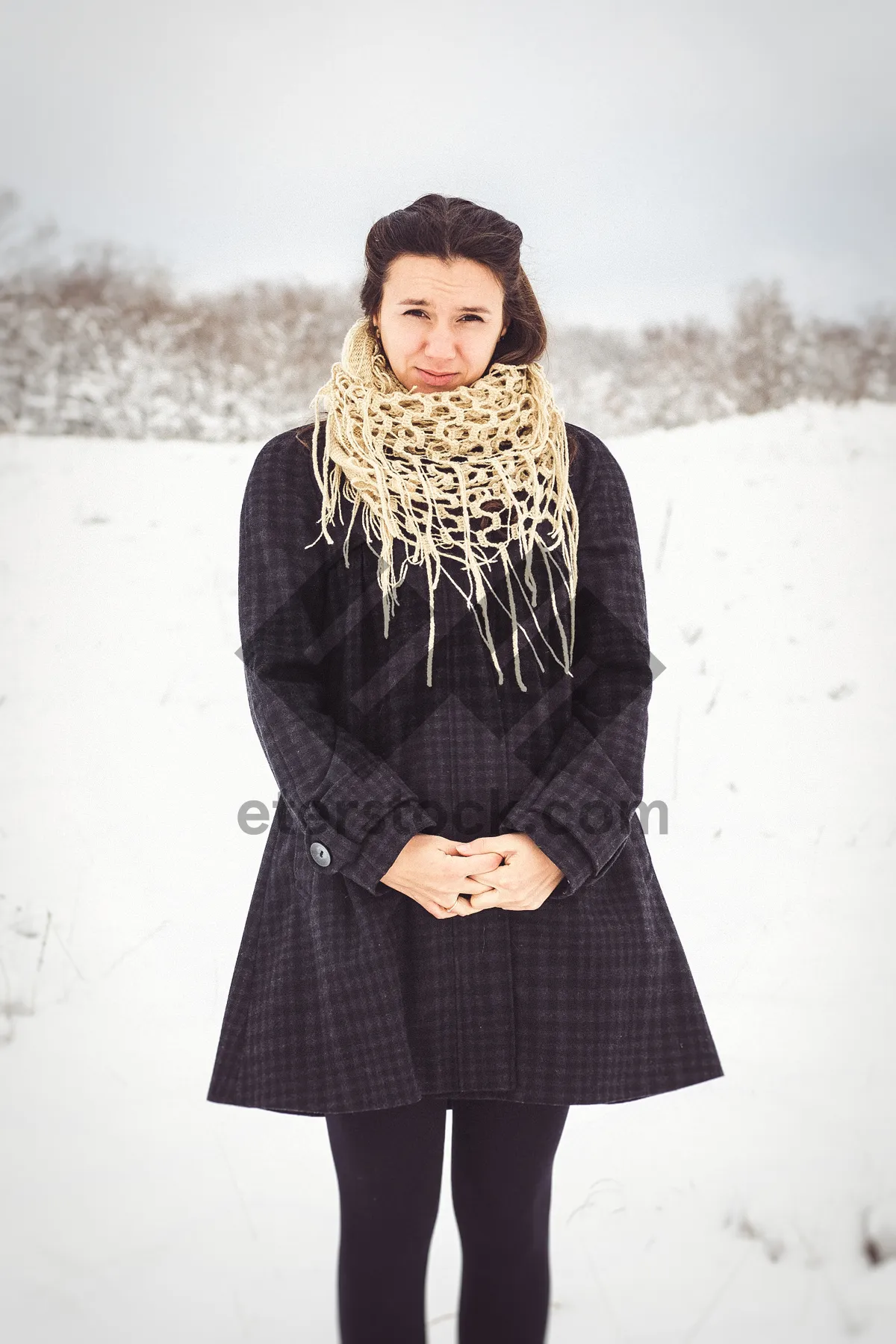 Picture of Smiling model in winter cloak on snowy day